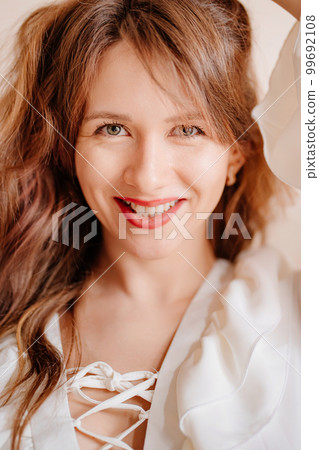 portrait of a beautiful woman in a white sexy dress with lacing and ruffles portrait of a beautiful woman in a white sexy dress with lacing and ruffles 99692108