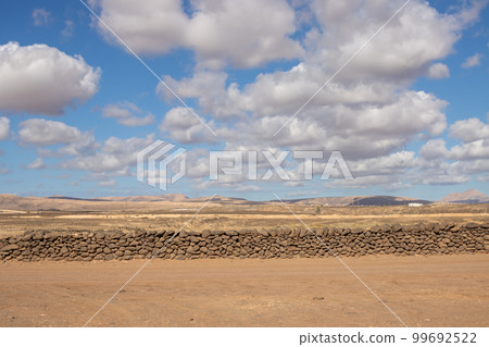 Lnadscape with a stone fence, Fuerteventura Lnadscape with a stone fence, Fuerteventura 99692522
