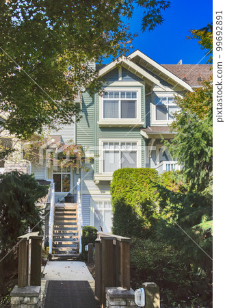 Shadow pathway to the entrance of residential townhouse 99692891