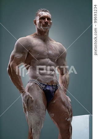 Muscular man with perfect body posing in studio Muscular man with perfect body posing in studio 99693234