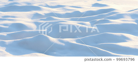 Natural winter background with snow drifts and falling snow 99693796