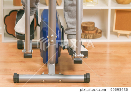 A man trains on an Elliptical Machine. Sports A man trains on an Elliptical Machine. Sports 99695486