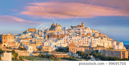 Attractive view on Ostuni white town skyline and Madonna della Grata church 99695708