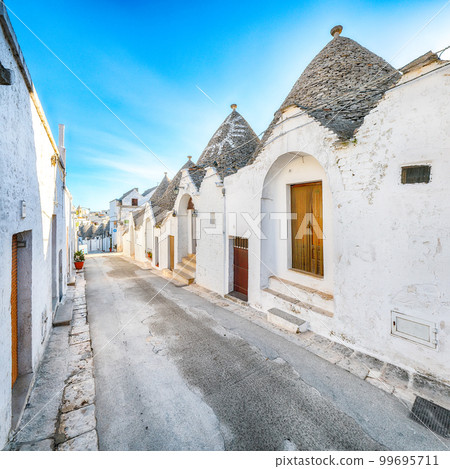 Trulli of Alberobello typical houses street view. Trulli of Alberobello typical houses street view. 99695711