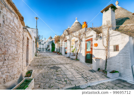 Trulli of Alberobello typical houses street view. 99695712