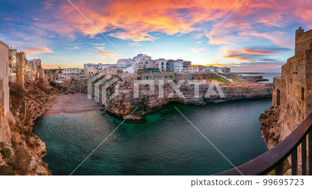 Stunning sunset at Cala Paura gulf with Bastione di Santo Stefano and Lama Monachile beach in background. Stunning sunset at Cala Paura gulf with Bastione di Santo Stefano and Lama Monachile beach in background. 99695723