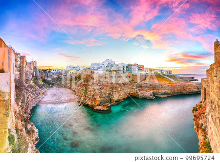 Stunning sunset at Cala Paura gulf with Bastione di Santo Stefano and Lama Monachile beach in background. Stunning sunset at Cala Paura gulf with Bastione di Santo Stefano and Lama Monachile beach in background. 99695724