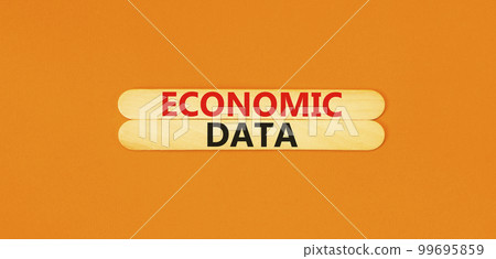 Economic data symbol. Concept words Economic data on wooden sticks. Beautiful orange table orange background. Business economic data concept. Copy space. 99695859