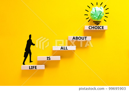 Choice and life symbol. Concept words Life is all about choice on wooden blocks. Beautiful yellow table yellow background. Businessman icon. Business choice and life concept. Copy space. 99695903