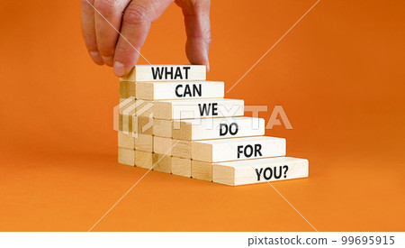 Support symbol. Concept words What can we do for you on wooden blocks on a beautiful orange table orange background. Businessman hand. Business motivational and support concept. Support symbol. Concept words What can we do for you on wooden blocks on a beautiful orange table orange background. Businessman hand. Business motivational and support concept. 99695915