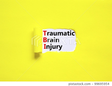TBI traumatic brain injury symbol. Concept words TBI traumatic brain injury on white paper on a beautiful yellow background. Medical and TBI traumatic brain injury concept. Copy space. 99695954