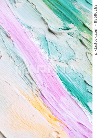 Smears of blue, pink, yellow and white paints on the wall 99696165