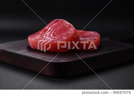 Two fresh slices of raw tuna fillet with spices and herbs 99697076