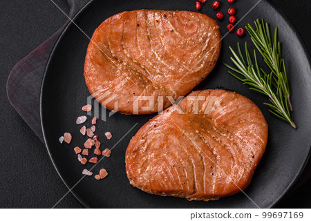 Two baked slices of tuna fillet with spices and herbs 99697169