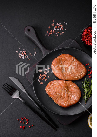 Two baked slices of tuna fillet with spices and herbs 99697176