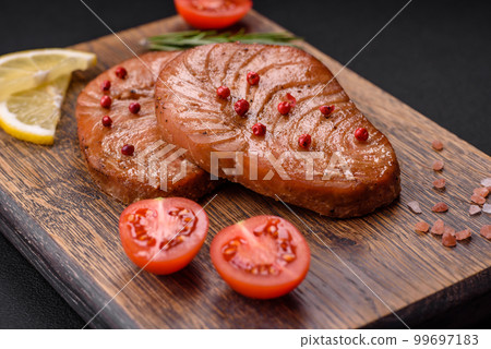 Two baked slices of tuna fillet with spices and herbs 99697183
