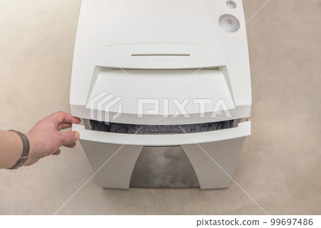 Industrial paper shredder. Paper shredder in the office, use and maintenance of professional office equipment. 99697486
