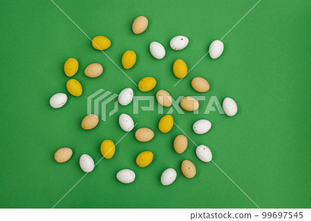 Chocolate Easter eggs on green background 99697545