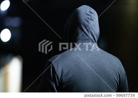 Back view of a suspicious man wearing a hood 99697739