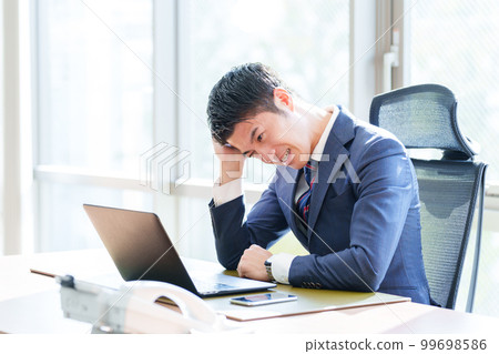 A businessman thinking in the office 99698586