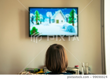 Little girl watching cartoons at home Little girl watching cartoons at home 99698824