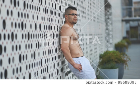 Muscular young man Arab posing against white background. 99699393