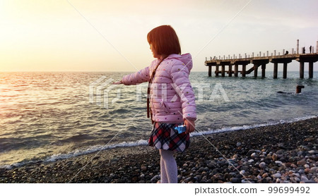 Little girl at the beach Little girl at the beach 99699492