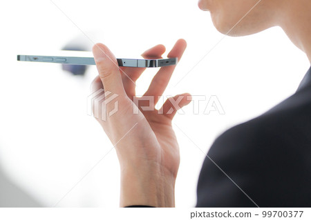 man speaking on speakerphone 99700377