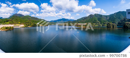 Ryumon Dam "Dam lake panorama view from the dam embankment road" Background is the morning sky and autumn leaves Ryumon Dam "Dam lake panorama view from the dam embankment road" Background is the morning sky and autumn leaves 99700786