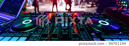 professional DJ music mixer at a party at an electronic concert professional DJ music mixer at a party at an electronic concert 99701194