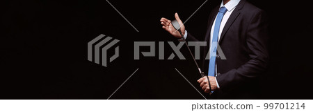 Male dominant businessman in a suit holding a leather whip Flogger for domination 99701214