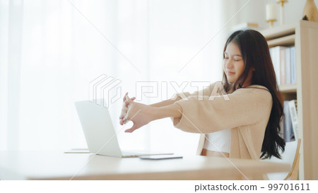 Young asian woman feeling pain in neck and shoulder after working on computer laptop for a long time Young asian woman feeling pain in neck and shoulder after working on computer laptop for a long time 99701611