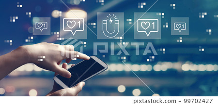Get more likes concept with person using smartphone 99702427