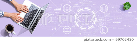 Backup concept with person using a laptop Backup concept with person using a laptop 99702450