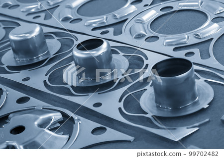 The close up scene of product parts from progressive die. The close up scene of product parts from progressive die. 99702482