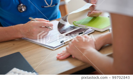Man gynecologist examining results of ultrasound diagnostics of pelvic organs 99702843