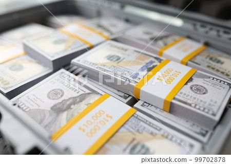 Briefcase full of stacks of dollar bills, pile of cash Briefcase full of stacks of dollar bills, pile of cash 99702878