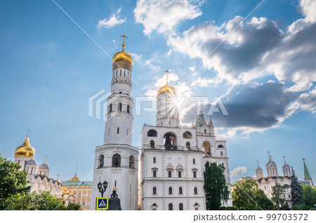 Ivan the Great Bell Tower, with Assumption Belfry on the right in Moscow Kremlin. Blue sky background with sunbeams 99703572