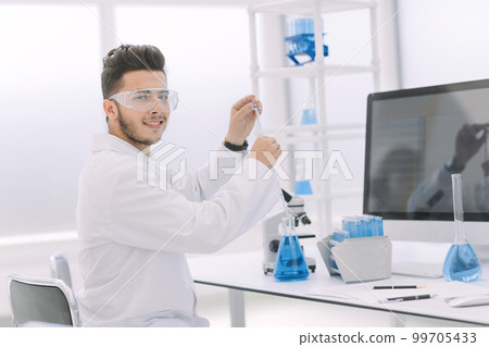 close up. modern scientist examines the liquid blue 99705433