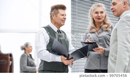 close up. group of employees discussing documents standing in the office 99705456