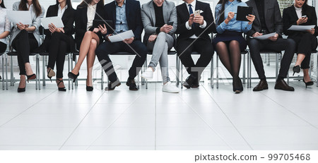 group of business people use their gadgets before starting a business meeting group of business people use their gadgets before starting a business meeting 99705468