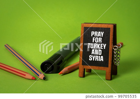 PRAY FOR TURKEY AND SYRIA. Miniature chalkboard with text PRAY FOR TURKEY AND SYRIA. Miniature chalkboard with text 99705535