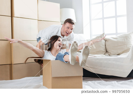 happy husband and wife having fun in their new apartment happy husband and wife having fun in their new apartment 99705650
