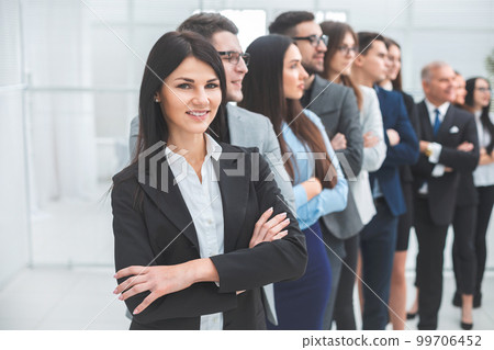 young business woman standing in front of her colleagues young business woman standing in front of her colleagues 99706452