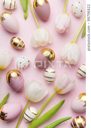 Easter golden eggs and pink tulips on pink background. Easter golden eggs and pink tulips on pink background. 99706822