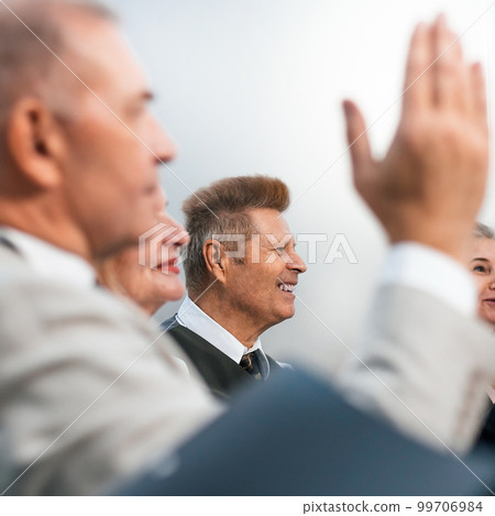 close up. business man asks a question during a business seminar. close up. business man asks a question during a business seminar. 99706984