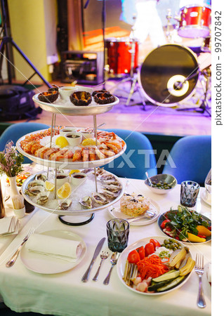 sea urchins, shrimp and shells with oysters on a platter with ice. sea urchins, shrimp and shells with oysters on a platter with ice. 99707842