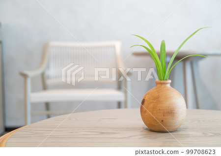 ceramic or porcelain vase with plant decoration on table in living room ceramic or porcelain vase with plant decoration on table in living room 99708623