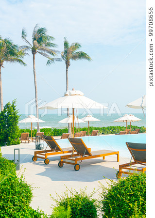 umbrella with bed pool around swimming pool with ocean sea background 99708656