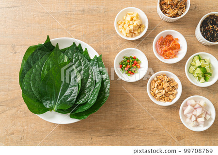 Miang kham - A royal leaf wrap appetizer Miang kham - A royal leaf wrap appetizer 99708769